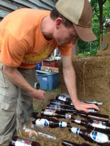 Patrick Sherwin, local Permie and renewables expert, integrating bottles into the bench